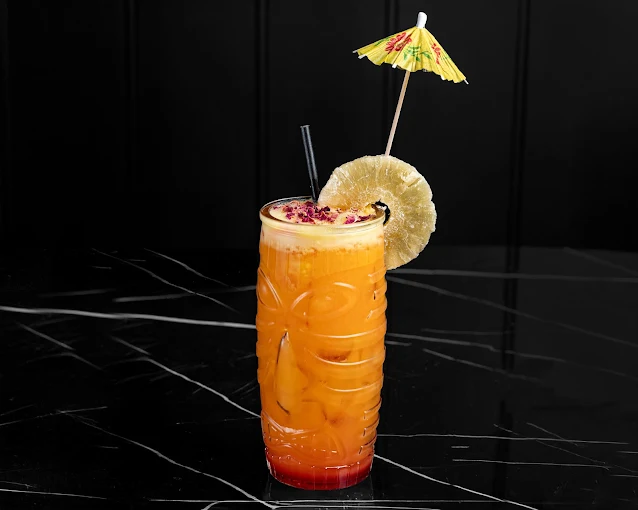 Tropical orange cocktail served at Illumina Bar